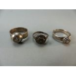 Three silver rings set with clear stones