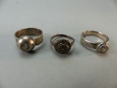 Three silver rings set with clear stones