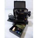 Folding portable Singer 221K sewing machine, in it's case and with electric lead and instruction