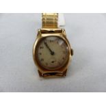 A 9CT GOLD EARLY 20TH CENTURY GENTS WRISTWATCH, gold and cream dial, cushion shaped Stolkace case,