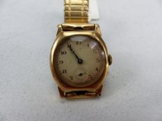 A 9CT GOLD EARLY 20TH CENTURY GENTS WRISTWATCH, gold and cream dial, cushion shaped Stolkace case,