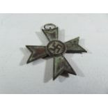 A WWII Second World War Nazi German Third Reich ' War Merit Cross ' medal. Dated 1939 to one side,