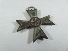 A WWII Second World War Nazi German Third Reich ' War Merit Cross ' medal. Dated 1939 to one side,