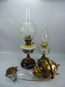 Two free standing oil lamps complete with chimneys (one Kronos by Hugo Schneider, marked 1914) along