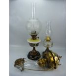 Two free standing oil lamps complete with chimneys (one Kronos by Hugo Schneider, marked 1914) along