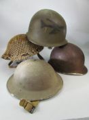 Four military helmets, two British, two US