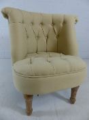 Cream upholstered boudoir chair with limed oak legs