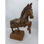 Carved wooden figure of a rearing horse. Possibly carved in fruitwood.