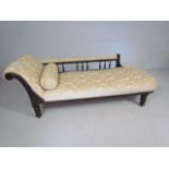 Newly upholstered cream fabric chaise lounge with spindle back