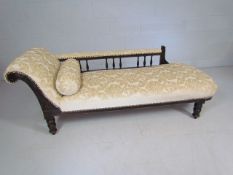 Newly upholstered cream fabric chaise lounge with spindle back