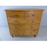 Bow fronted pine chest of drawers on turned feet with three large drawers and two over