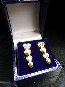 Pair of yellow gold diamond-set heart shaped graduated earrings