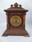 Wooden carved mantle clock with gold face and pendulum. Marked Ansonia Clock Co. New York to