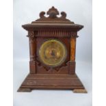 Wooden carved mantle clock with gold face and pendulum. Marked Ansonia Clock Co. New York to