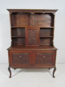 Greenman oak dresser with typical Greenman head to doors.