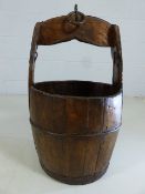 Rustic bound wooden water bucket with handle and iron loop