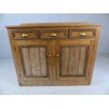 Antique pine sideboard with three drawers, cupboards under and brass cup handles
