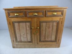 Antique pine sideboard with three drawers, cupboards under and brass cup handles