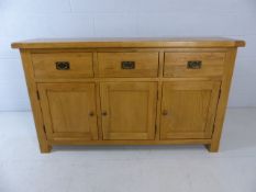 Modern light wood sideboard with three small cupboards and three drawers over