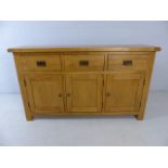 Modern light wood sideboard with three small cupboards and three drawers over