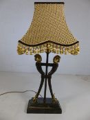 Three-stemmed occasional lamp with brass horse head finials and brass hoofed feet on marble plinth