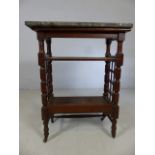Marble topped three tier table with fretwork to sides and ceramic castors