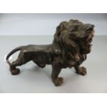 Cast metal figure of a roaring lion