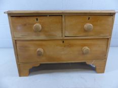 Small low antique pine chest of one large and two small drawers