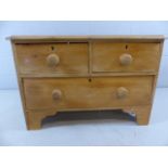 Small low antique pine chest of one large and two small drawers