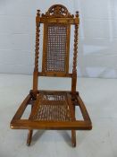 Folding campaign style chair with wicker work and barley twist detail