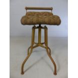Brass adjustable machinist stool with buttoned upholstered seat