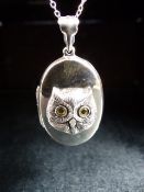 Silver photo locket with embossed image of an owl