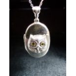 Silver photo locket with embossed image of an owl