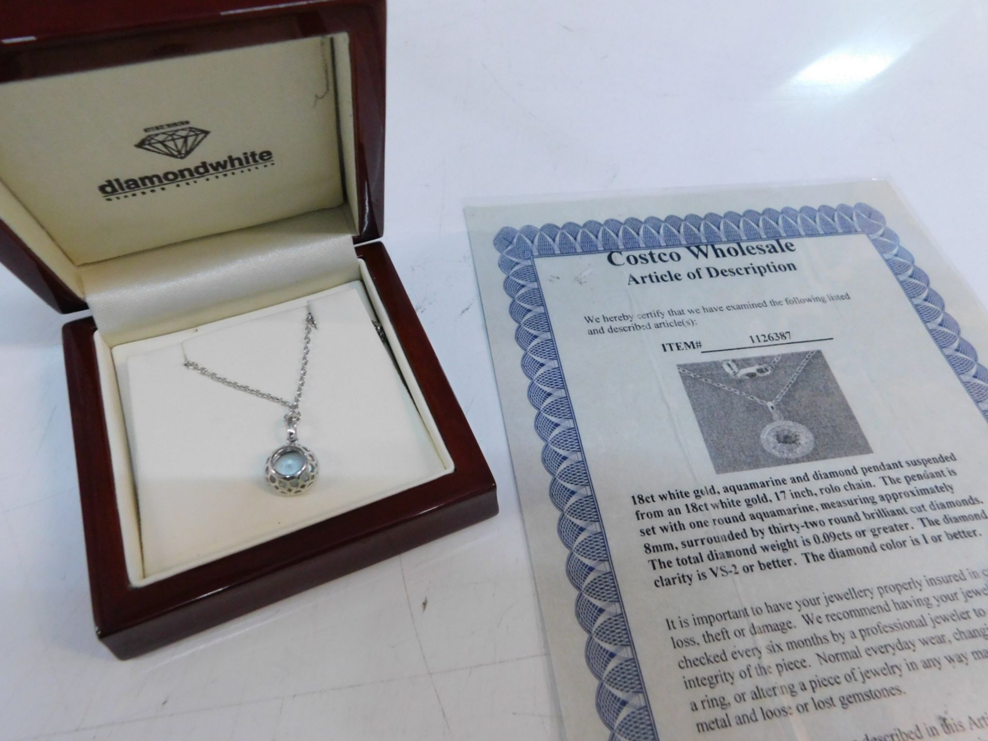 1 BOXED 18CT WHITE GOLD AQUAMARINE AND DIAMOND PENDANT SUSPENDED FROM A 18CT WHITE GOLD ROUND