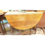 Larger light oak twist stemmed double gate leg occasional table