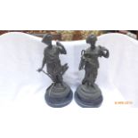 Pair of Spelta figures of a male huntsman and lady water carrier each on circular plinth