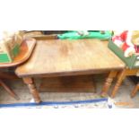 Mahogany dining table with spare leaf on shaped reeded legs on pot casters