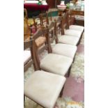 Six carved oak framed dining chairs the padded seats of each upholstered in beige dralon