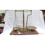 Set of Avery balanced pan scales with bell shaped and other brass weights