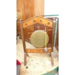 Circular brass drum dinner gong on carved mahogany frame with long handled brown leather hammer