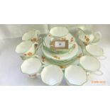White ground hand painted bone china part tea set with apple green border and orange floral sprays