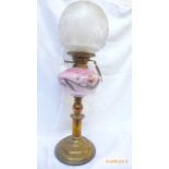 Brass circular based early 20th century oil lamp with floral patterned pink bowl and etched domed