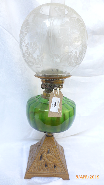 Brass shaped base early 20th century oil lamp with dark green bowl and domed etched clear glass