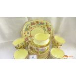 Yellow ground multi-coloured floral patterned Crown Staffordshire bone china tea service,