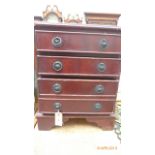 Brown painted miniature chest of four drawers