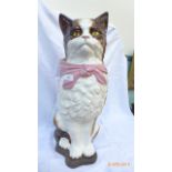 Large decorative figure of a brown and white cat with pink shawl on wooden plinth (25" high)