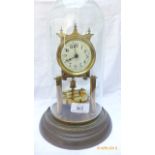 Brass and enamel mantel clock on circular brass base within domed glass case