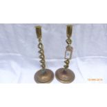 Pair of brass twist stemmed candlesticks each on circular base (11" high)