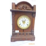 Carved oak hooded cased mantel clock ex.