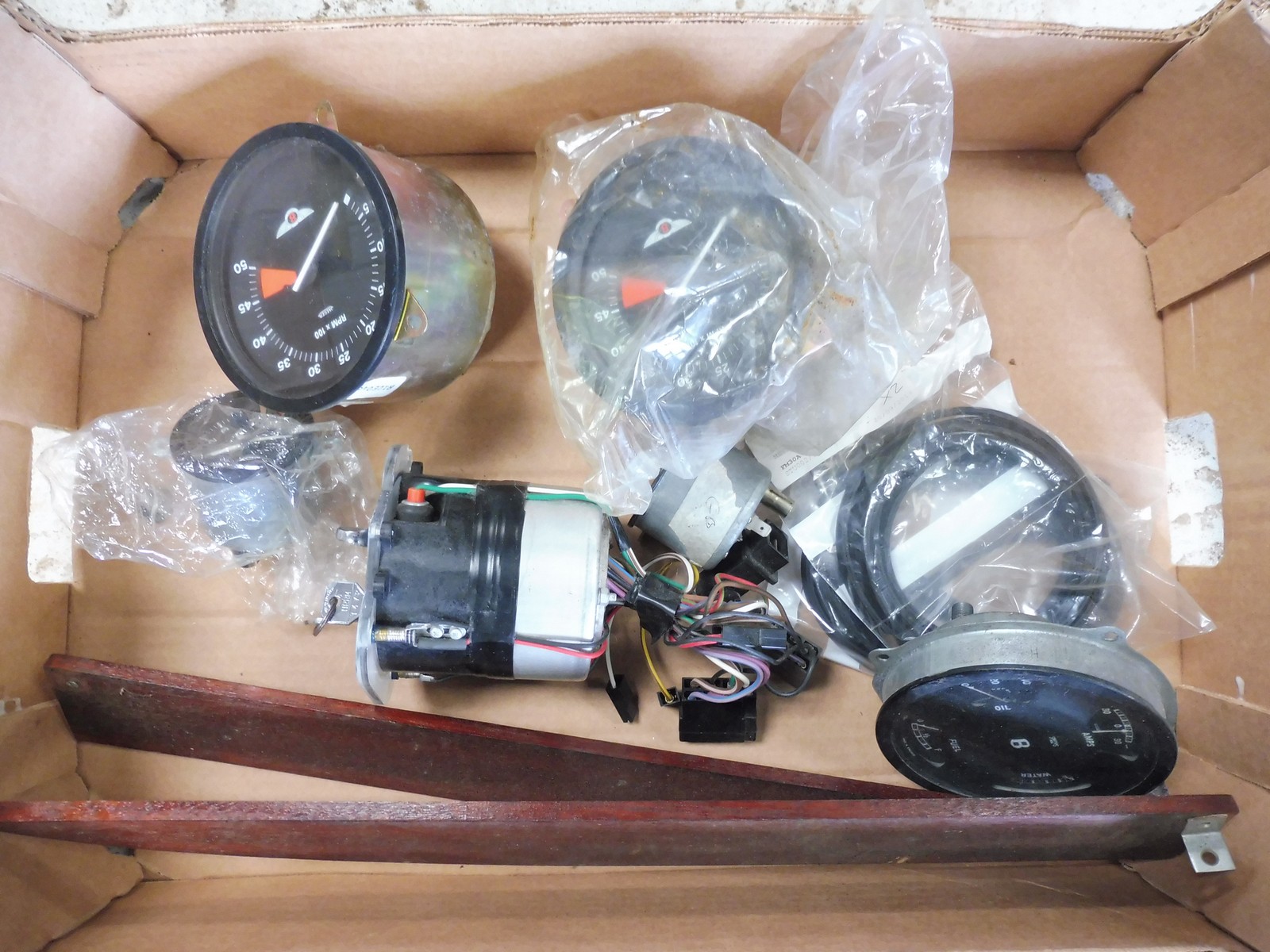 A box of assorted dashboard instruments etc.